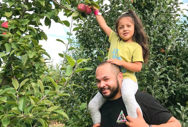 Picture of father and daughter picking apples - Fall Bucket List
