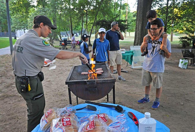 Urban Park Ranger mans the grill at a campout