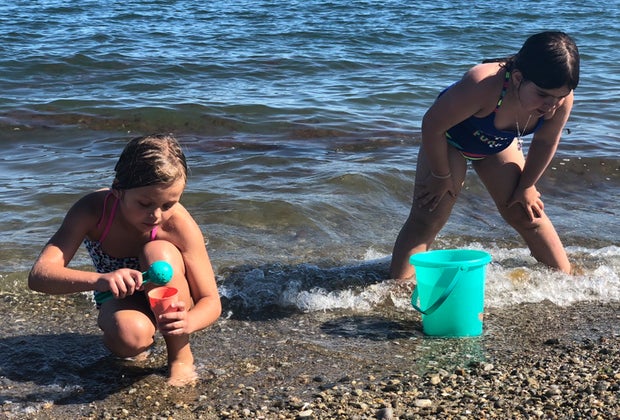 Photo of kids in the surf at a beach - End of Summer Bucket List