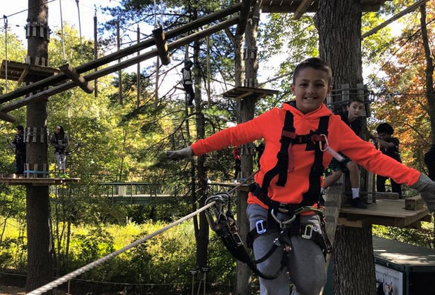 Photo of child at outdoor ropes course - Fall Bucket List
