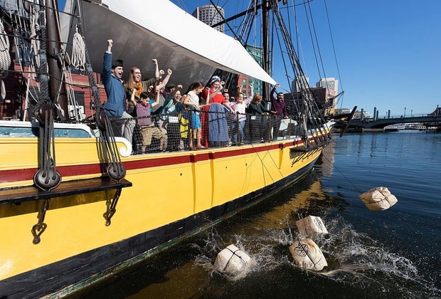 Image of a Boston Tea Party reenactment.