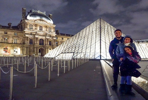 Stop by The Louvre at night for a breathtaking photo op with kids in Paris