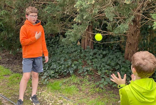 Hiking Games for Kids That Turn Walks into Adventures: kids playing catch with a tennis ball