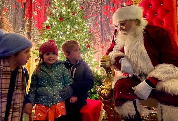 Kids pose with Santa at The Village at Anne Ellen