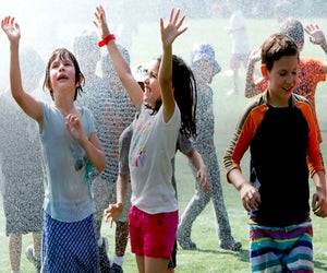 Head to Asphalt Green's Upper East Side campus for an afternoon of wet and wild fun on Sprinkler Day. Photo courtesy of Asphalt Green