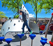 A top Queens playground, Paul Raimonda Playground offers sprinklers, climbing, and shady seating. Photo by author