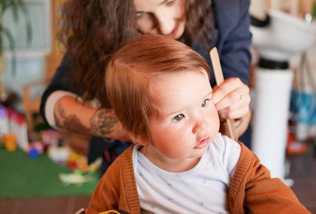 Kids haircuts in NYC: Stock image of a baby getting a haircut