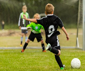 Boy shooting a goal. Photo courtesy Bigstock