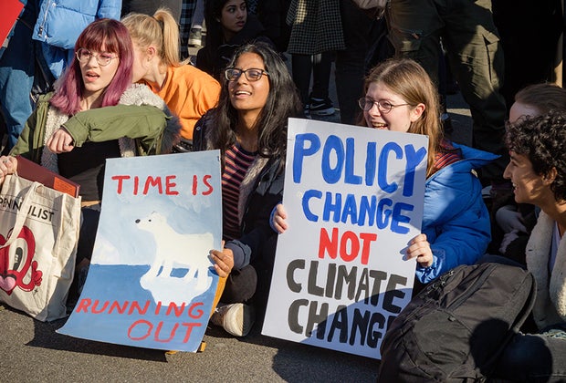 Climate Change Anxiety in Kids photo of teens sitting in at a protest
