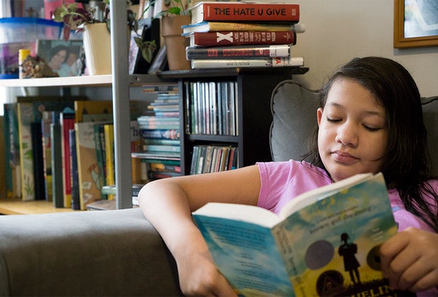 GIrl reading in chair Brown Girl Dreaming Black history for children