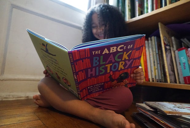Don't be bored, this girl is smiling because she's reading a great book.