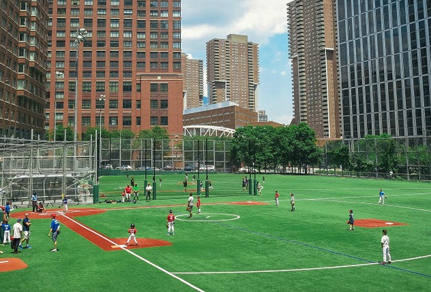 Things to do in Battery Park kids playing baseball