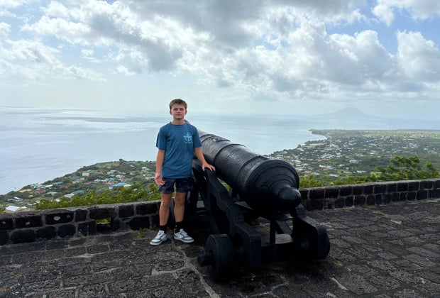 Boy at a canon at Brimstone Hill Fortress National Park, a historic site with extraordinary panoramic views.