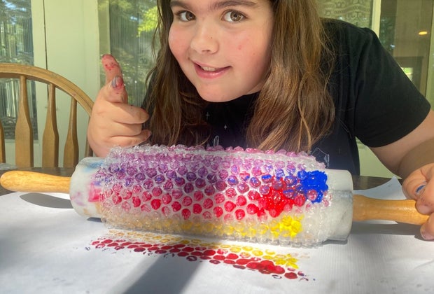 Bubble wrap can wrap around a rolling pin and make a modern art masterpiece.