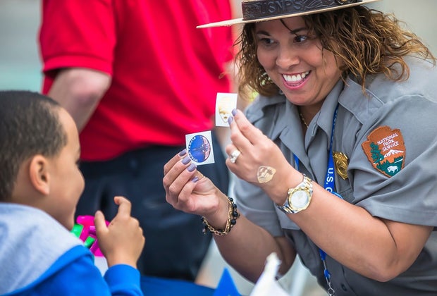 Image of Bunker Hill Monument guide interacting with a child.
