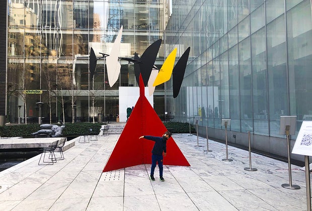 Boy in front of 'Butterfly' in the garden at MOMA