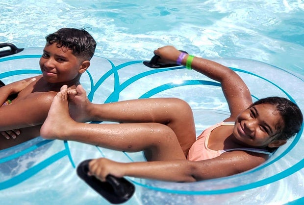 Image of kids relaxing on pool floats.