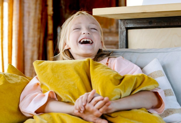 Girl laughing at riddles for kids