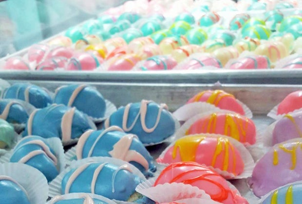 a pasty case full of colorful easter pastries