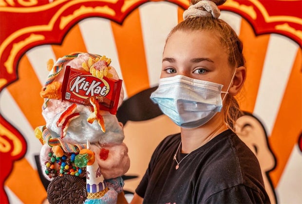 teenager holding giant ice cream cone coney waffles Asbury Park New Jersey boardwalk