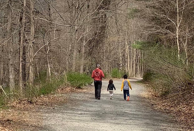 kids and dad hike along a trail in the woods at Croton Gorge Park