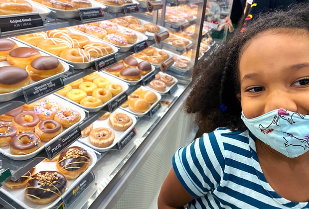 a girl at krispy kreme donuts