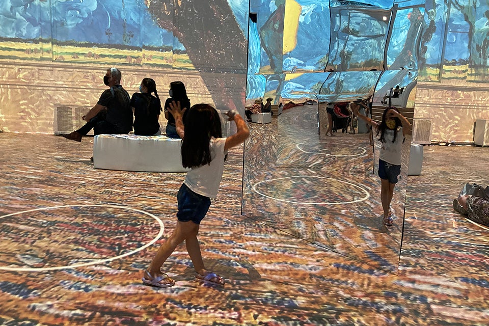 Mirrors put kids right in the middle of the art at Immersive  Van Gogh. Photo by Maureen Wilkey 