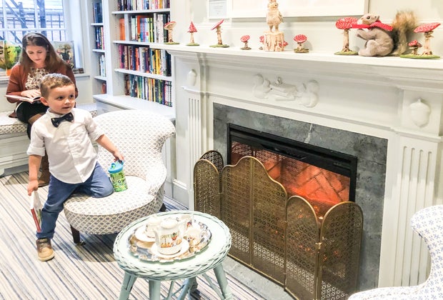 Image of child and adult by fireplace at Beacon Hill Books & Cafe