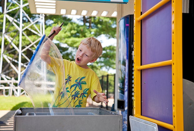 Image of child playing with bubbles at the Ecotarium.