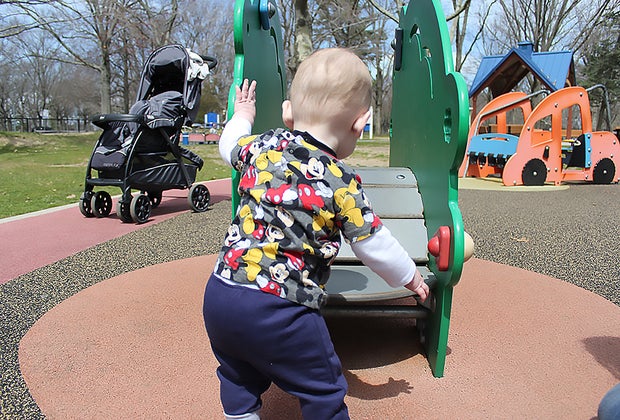 toddler plays at a playground