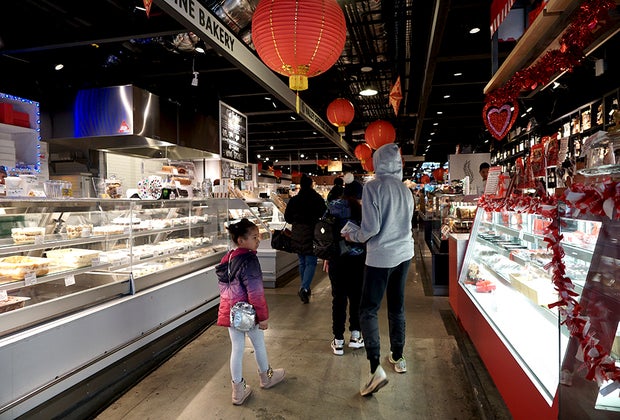 Kids walking in Essex Market, a food hall in New York City
