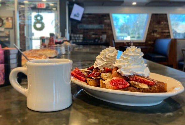 Photo of plate of French toast with fruit and whipped cream