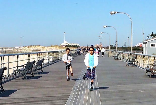 Best free things to do on Long Island this summer: kids scooting on a boardwalk
