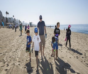 Sweep the beach at the Heal the Bay Beach Cleanup. Photo courtesy of Heal the Bay
