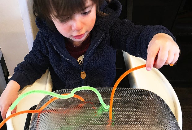 Turn a Highchair into a Baby Activity Center: A great pincer grasp activity.