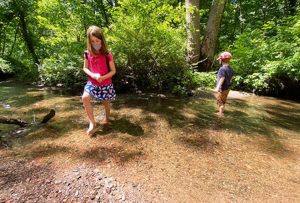 Hiking Games for Kids That Turn Walks into Adventures: kids wading in the water in a pond