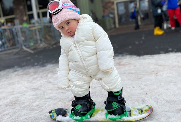 Little girl toddler snowboarding at Hunter Mountain in New York state