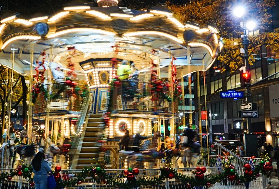 The double-decker Christmas Carousel is now spinning at Greeley Square through the holidays. Photo by author