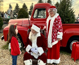 Mr. and Mrs. Claus have a great photo-op with a little red truck at Santa's Christmas Tree Farm in Cutchogue. Photo by Jennifer Voit