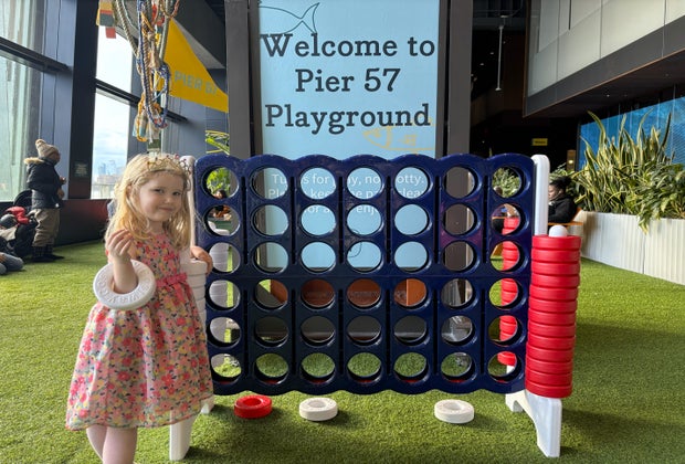 Pier 57 indoor playground: Little girl playing giant Connect Four