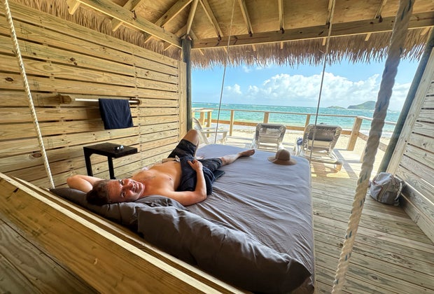 Private beach cabanas where you can see the beach, relax in the shade, and sleep on a hanging bed.