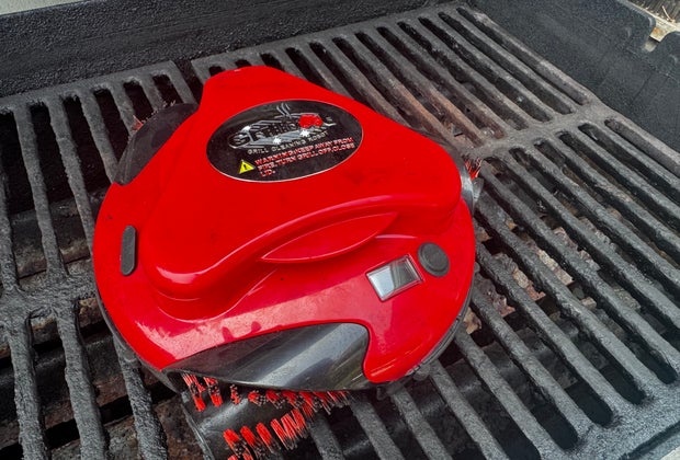 The Grillbot at work on a dirty grill.