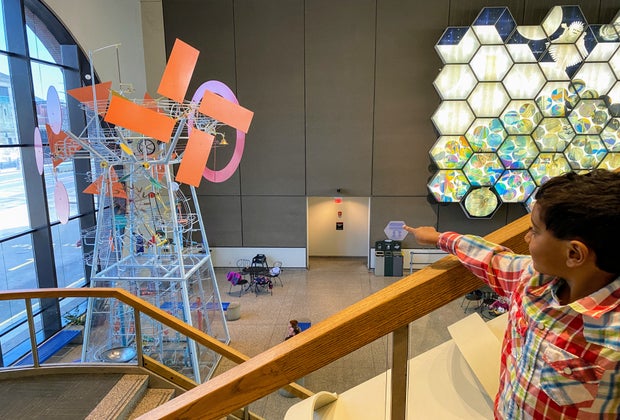 Picture of child admiring kinetic sculpture at Museum of Science Boston.