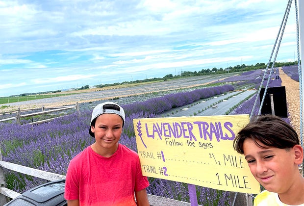 kids pose in front of the lavender trails sign
