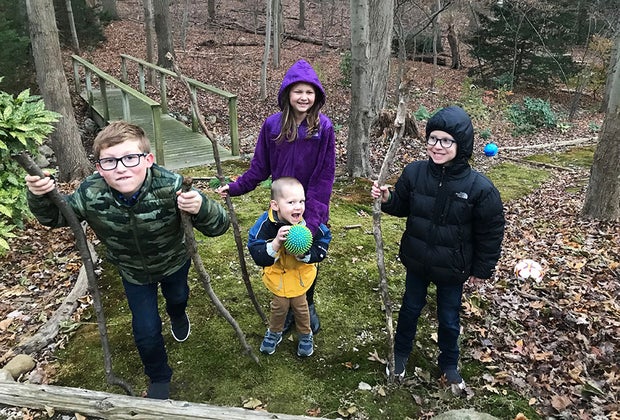 Hiking Games for Kids That Turn Walks into Adventures: kids on a hike carrying walking sticks
