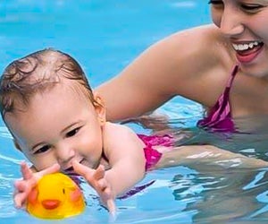 Baby swim classes are all about having fun and getting comfortable in the water. Photo courtesy of KIDS FIRST Swim Schools