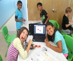 At L3 Academy young robotics campers build in a group using a design engineering process for feedback and evaluation