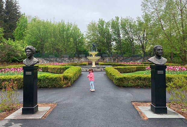 Little girl in landscaped garden at Lasdon Park & Arboretum