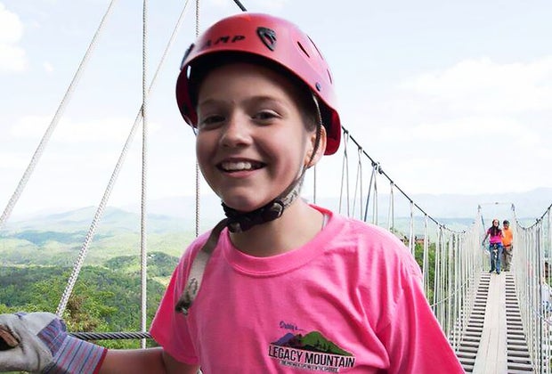 child walking across a sky bridge