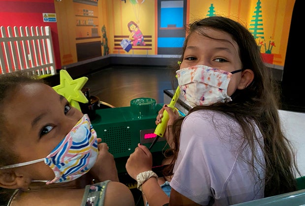 Girls with wands on Legoland Discovery Center's Imagination Express